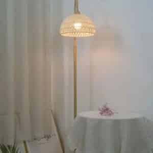 Lampadaire Rotin au Design Minimaliste sur fond blanc derrière une table
